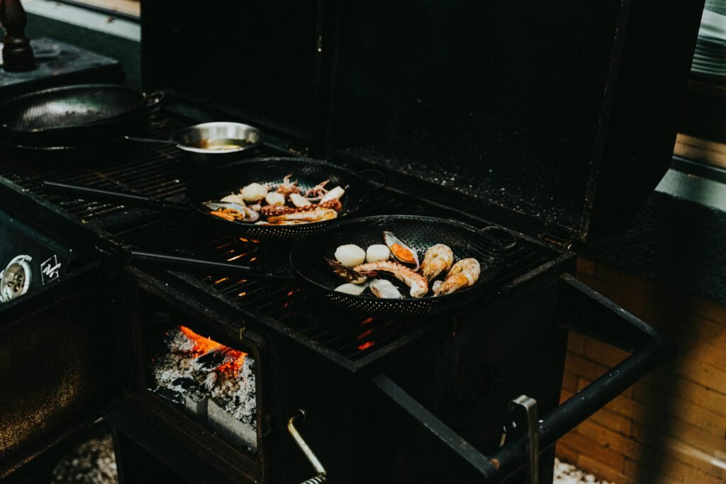 Eureka camp stove preparing a gourmet meal at a serene outdoor campsite, highlighting efficient and enjoyable outdoor cooking.