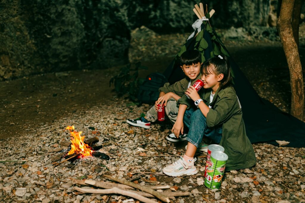 Happy campers enjoying delicious make-ahead meals easily reheated over a campfire, highlighting stress-free outdoor dining and smart meal preparation.