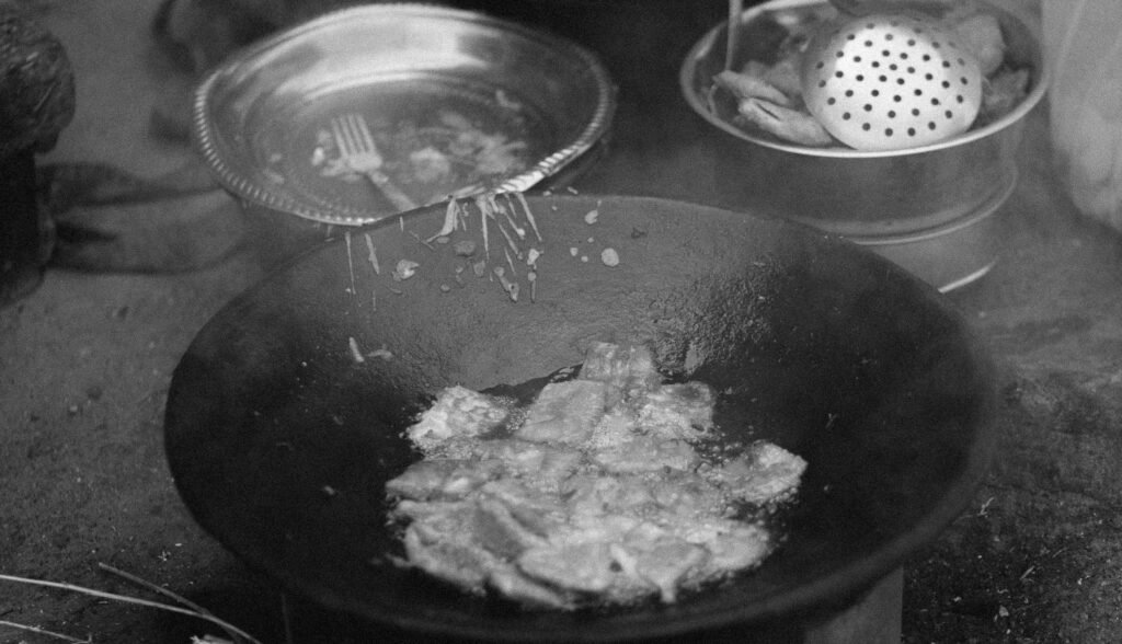 Portable propane hot plate cooking a hot meal outdoors, ideal for camping and emergency situations.