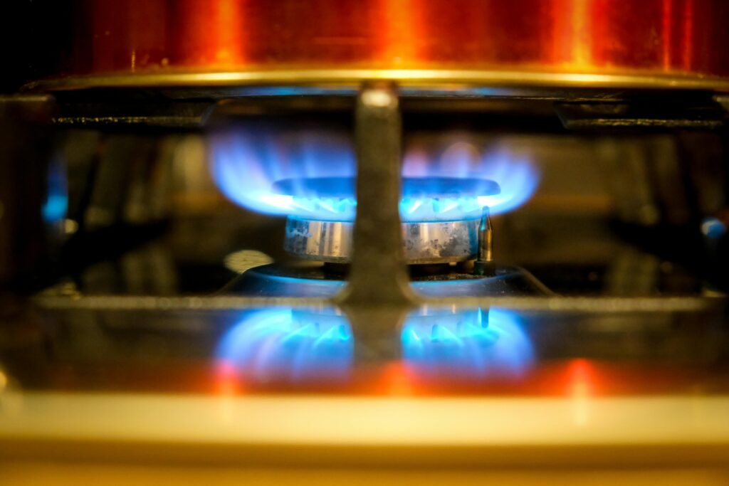 Modern portable double burner hot plate in a kitchen, showcasing its versatile cooking capabilities and extra stovetop space for efficient meal preparation.
