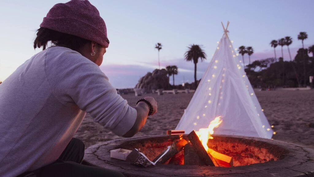 A perfect camping idea illustrated by a cozy campsite with a glowing tent and a warm campfire in a serene forest at night.