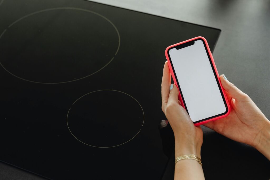 Sleek portable single burner induction cooktop on a bright kitchen counter, illustrating a space-saving and versatile cooking solution for compact living.