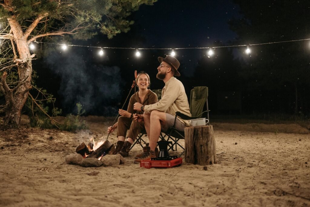 A person relaxing in a camp chair and eating a simple meal from a single pan, illustrating the concept of lazy camping food for a stress-free outdoor adventure in 2025.